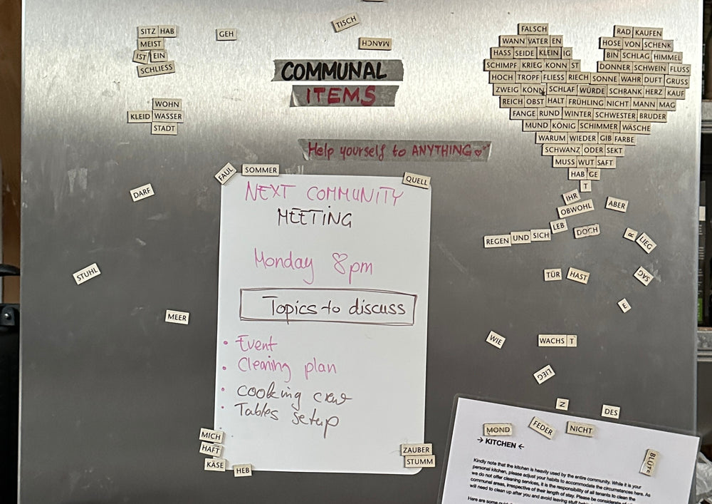 A written card and many small notes clinging to a metal surface in the home.