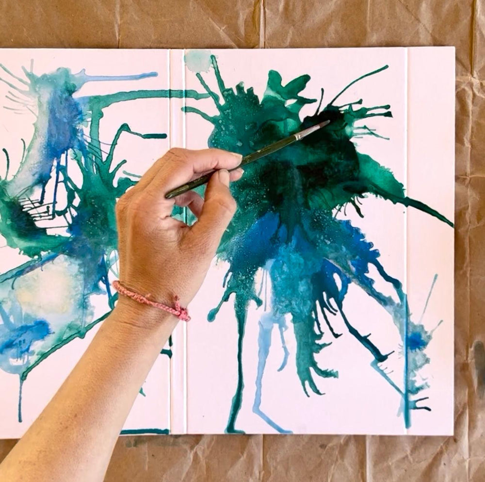 Hand painting on the white folder in blue and green.