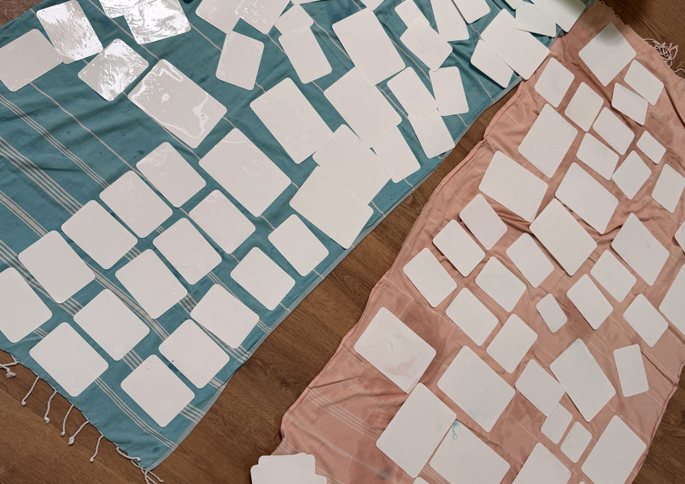 Many cleaned cards lie drying on two spread-out towels.