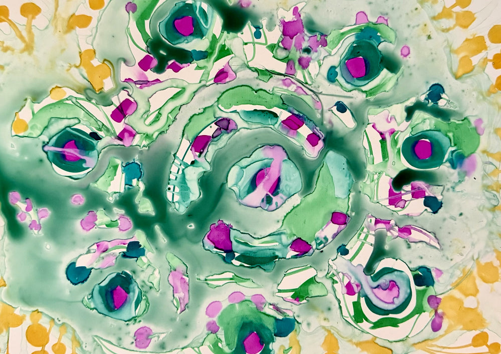 Green and pink colour run into each other on the smooth surface.